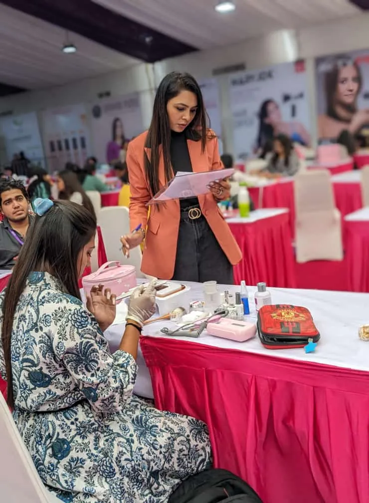 Bhumika Panchal assessing professional nail technique at a live competition